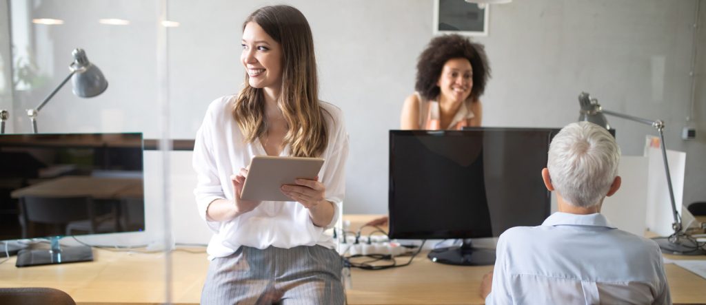 an image showing a happy team in an office pointing at the importance of labour cost handling