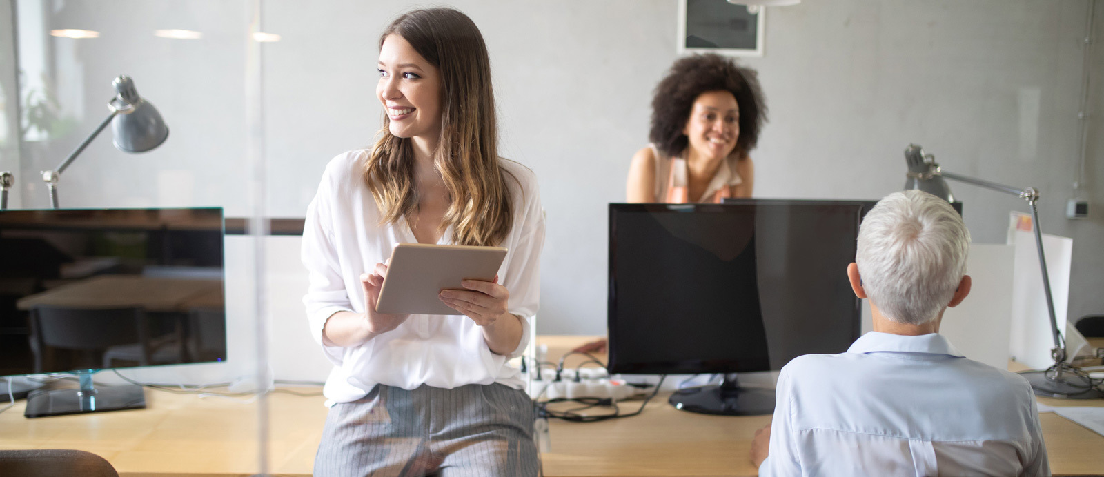 an image showing a happy team in an office pointing at the importance of labour cost handling